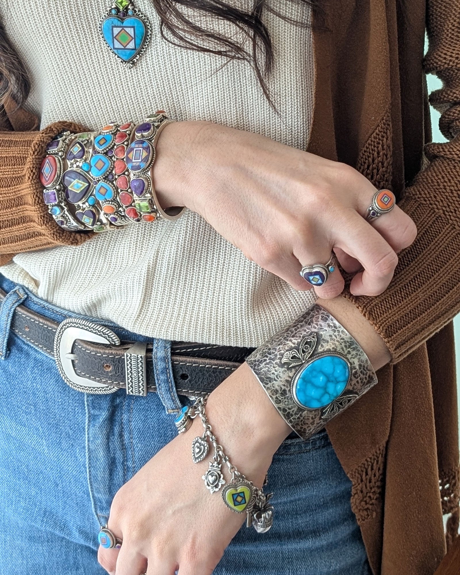 aldrich art studio woman wearing a stack of handmade sterling silver and gemstones bracelets and cuffs
