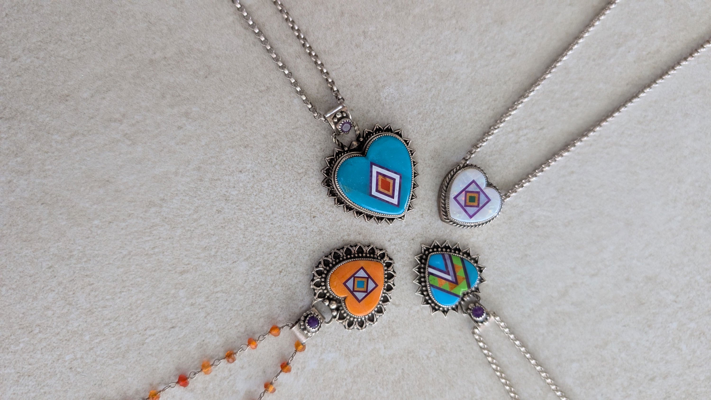 four aldrich art studio heart shaped pendants set in sterling silver